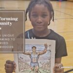 young boy holding a picture of an athlete.